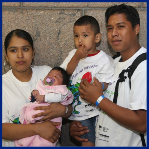 man, woman, boy child and baby posing for image