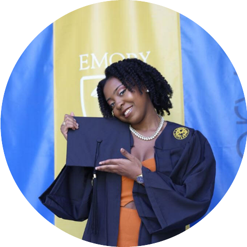 girl posing with graduation cap and gown