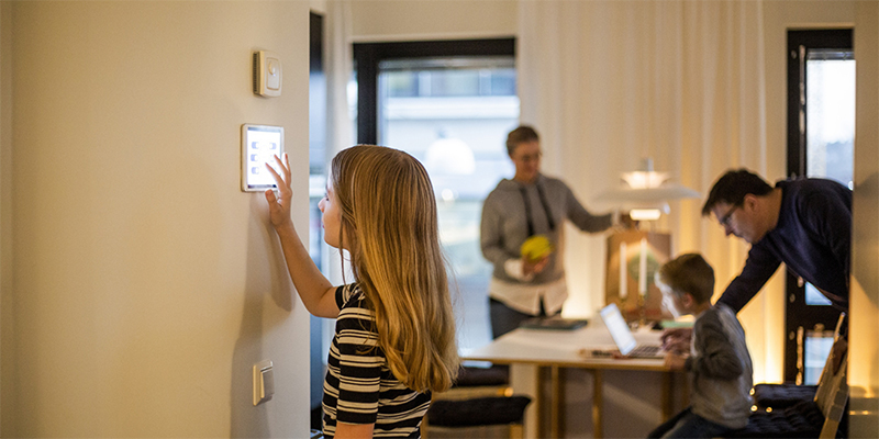 Youth Adjusting Smart Thermostat