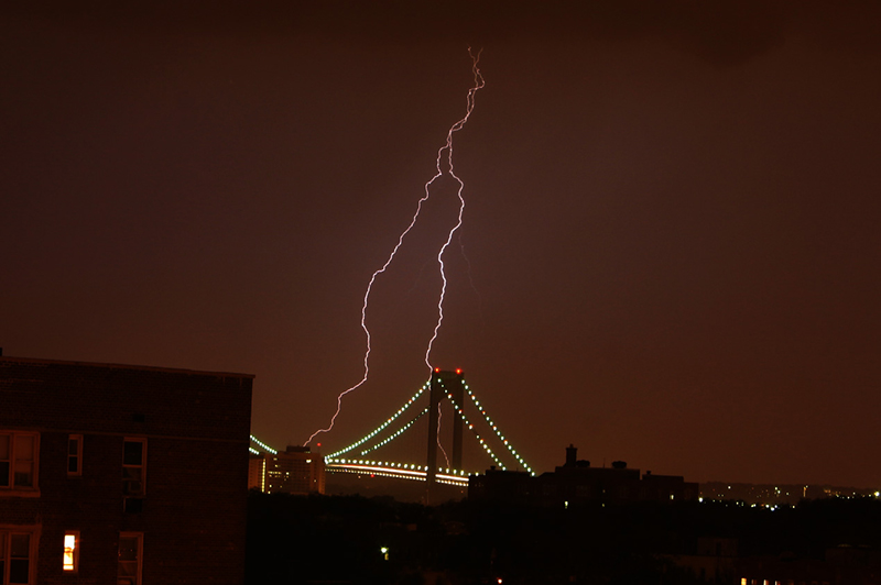 A lightning storm over a bridge.