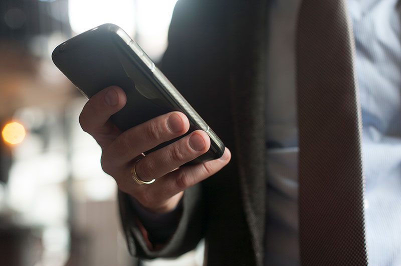 A hand holding a smartphone