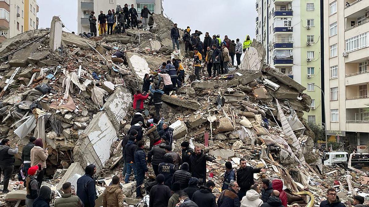 A group searches for survivors in a collapsed building following the earthquake.
                                           
