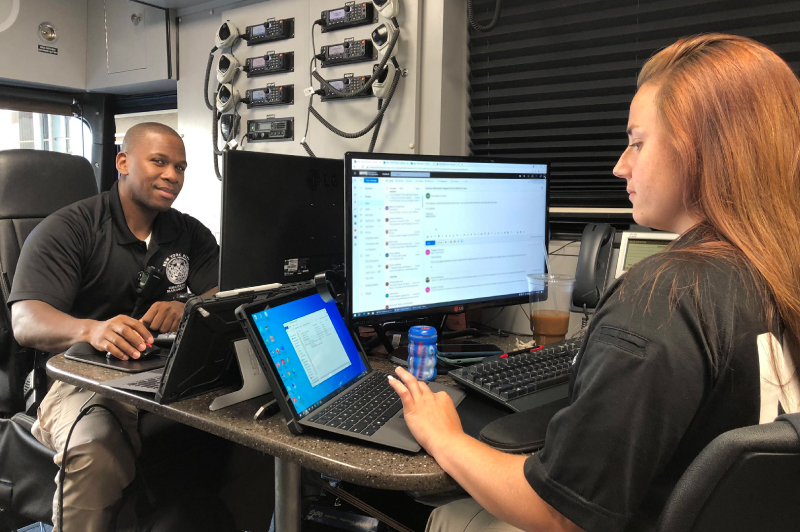 Two EM workers in ione of the agency command vehicles.