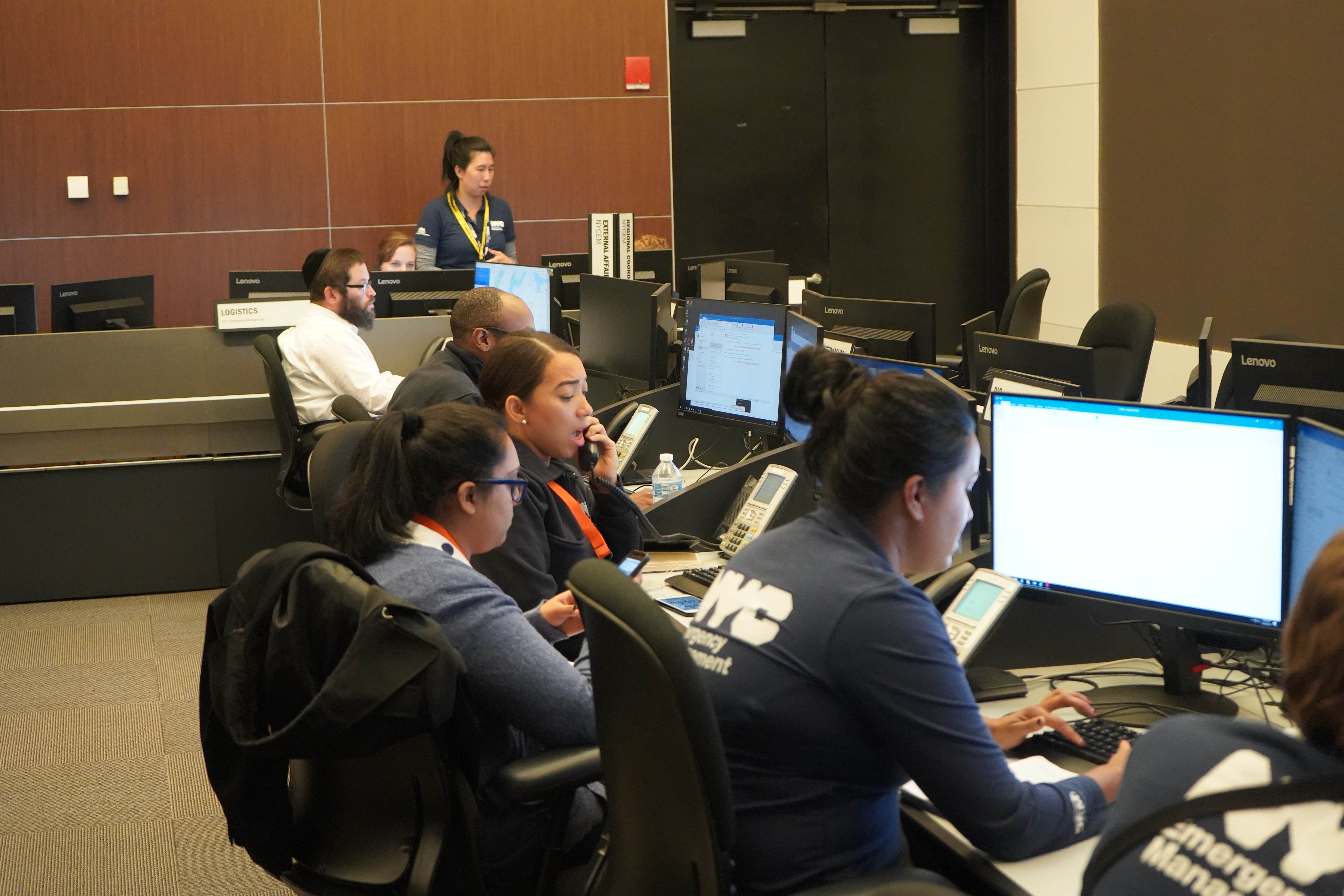 NYCEM staff members at computers and on the phone.