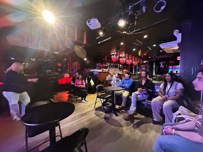 SYEP Pride Event Participants listen to Co-Owner of the Stonewall Inn Stacy Lentz discuss the space's rich history.  