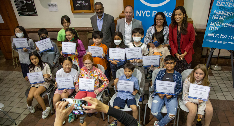 Kids holding up certificates