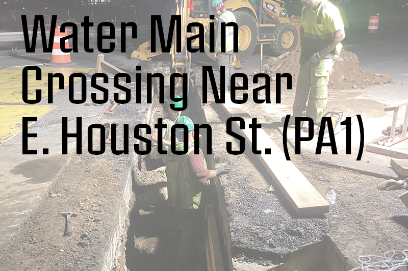 Photo of workers in water main trench