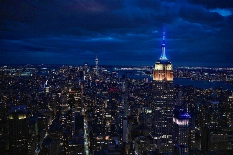 The Empire State Building lit up the New York City skyline in yellow, white and blue—with red in the mast—on Sunday, May 18, 2025, to kick off National EMS Week 2025.
                                           
