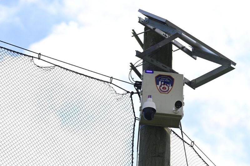 The solar-powered cameras, which use artificial intelligence to detect smoke and flame activity, are positioned high above the ground, similar to traffic cameras, and provide live video feeds to the Fire Department Operations Command (FDOC).