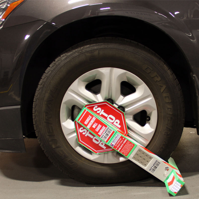 Photo of a boot placed on the front tire of a car