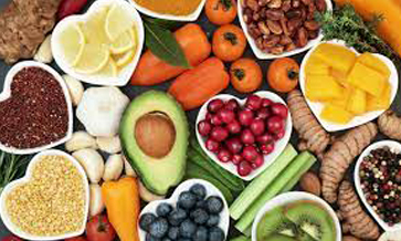 A still life photo of fruits, vegetables, herbs, and spices.