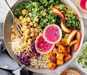a bowl of foods containing vegetables, nuts, and rice