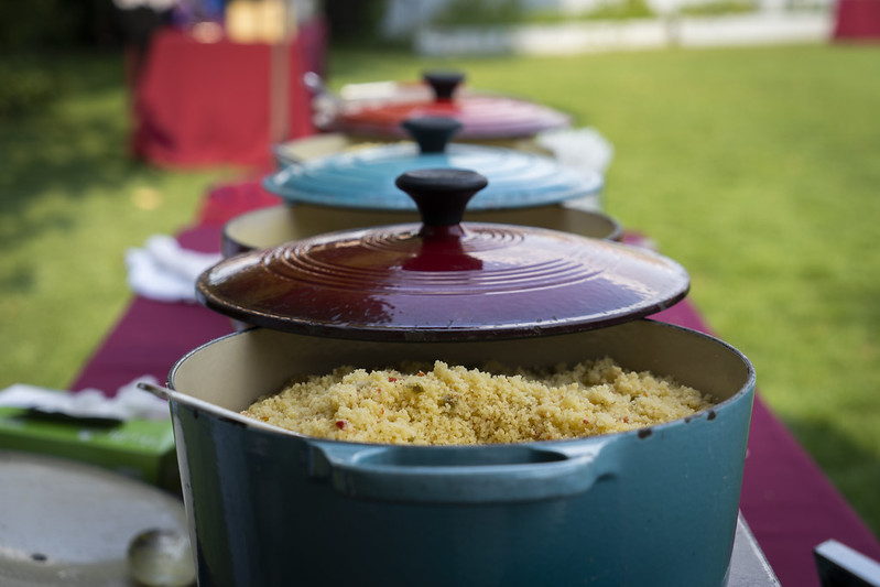 3 pots on a table with one pot open to show the grains inside