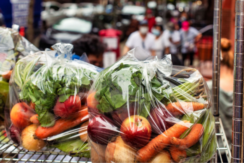 A still life photo of fruits, vegetables, herbs, and spices.