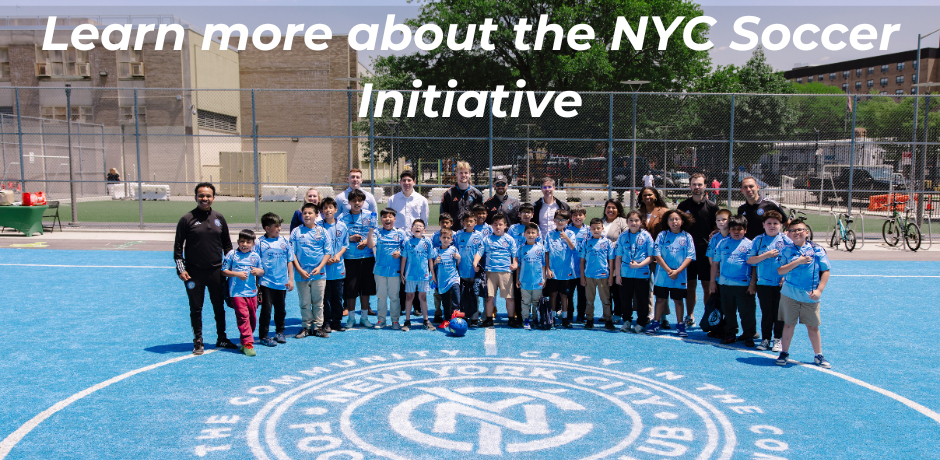 a group of adults, and children stand together in a field next to a school. Learn more about the NYC Soccer Initiative. 
                                           