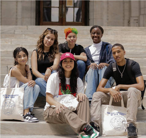 Six City University of New York students sit on marble steps