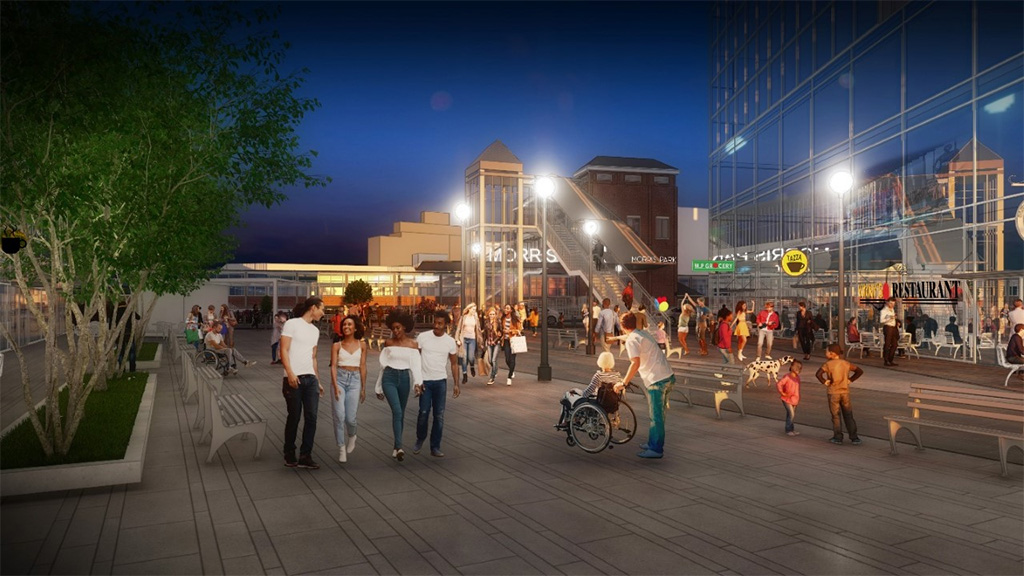 A rendering of people in Morris Park Plaza that shows a new constructed train station and storefrtons