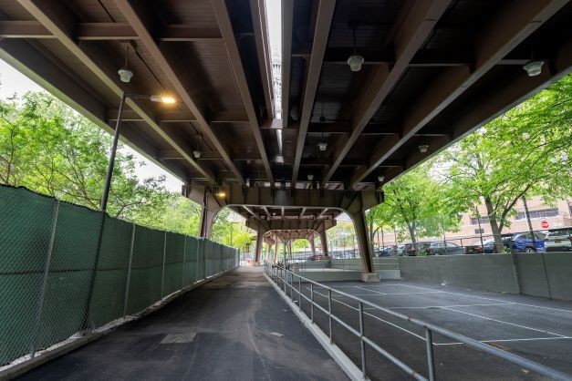 South side view of a public space under the Brooklyn Bridge opening