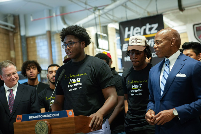 mayor adam is standing next to a group of Hertz's employees
