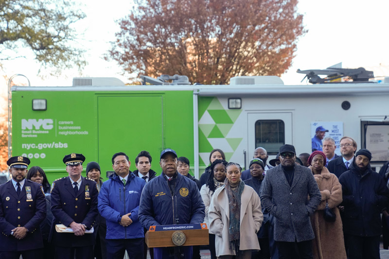 Mayor Adams accompanied by other officials speaks about combating gun violence
                                           