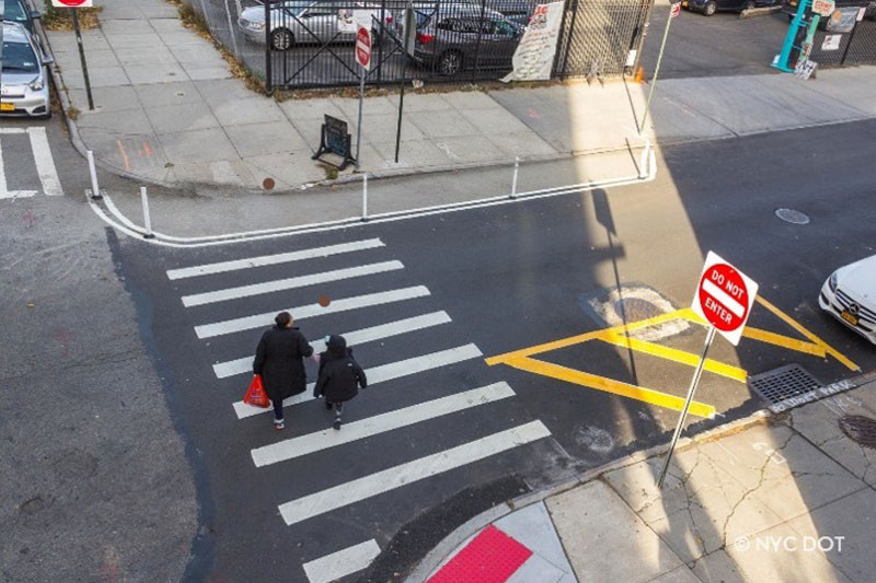 two people are crossing the road.