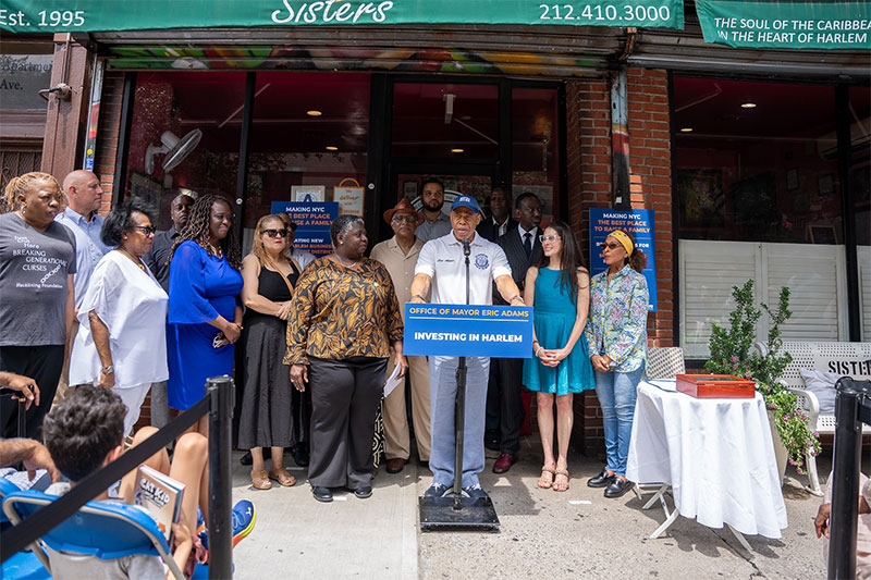 Mayor Adams standing outside a business with S B S Commissioner Dynishal Gross and other officials to sign legislation to create new Business Improvement District in East Harlem
                                           
