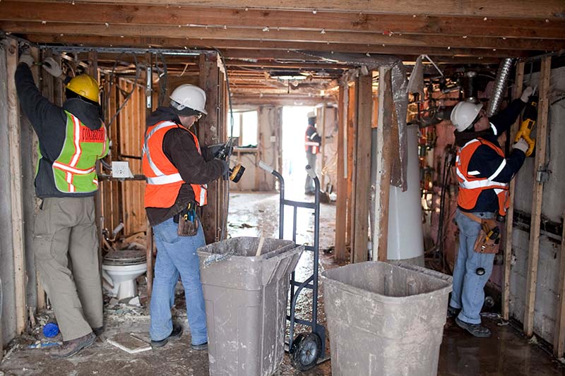 construction workers inspecting frame of a house