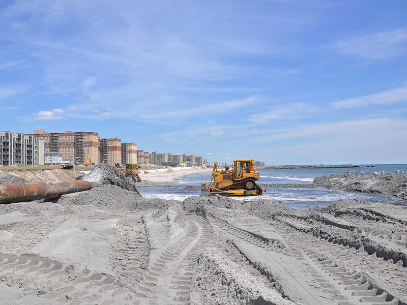 Shoring up sand dunes on Rockaway Beach