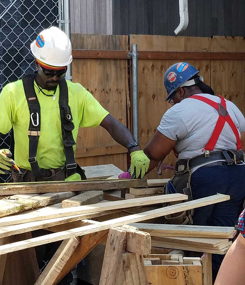Two workers at a rebuilding site