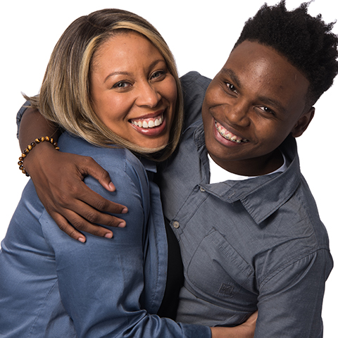 A mother and son who found affordable housing through NYC are hugging and smiling.