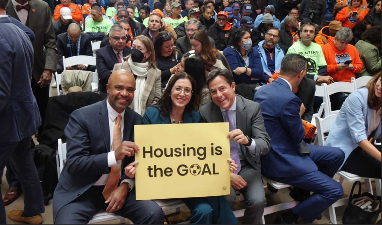 HPD Commissioner Carrión Jr., Chief Housing Officer Katz, and DCP Chair Garodnick holding a sign