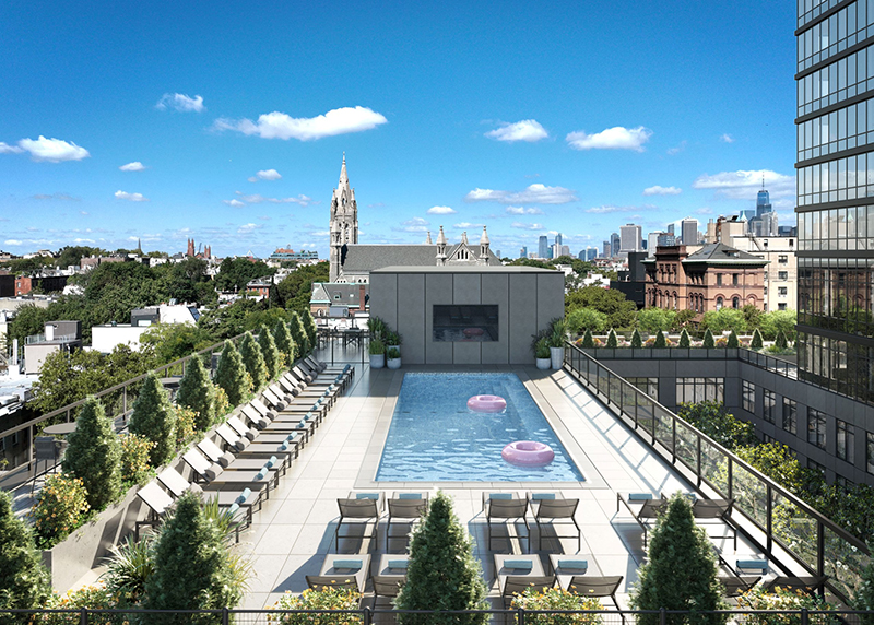 an aerial look at an apartment building's room that has an outdoor pool and views of the New York City skyline in Gowanus, Brooklyn