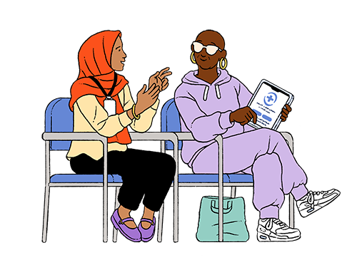 A seated young female digital navigator in a hijab helps a middle-aged Black woman use a telehealth portal on her tablet.
