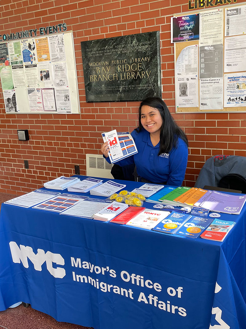 Photo of MOIA Representative Holding up Flyers