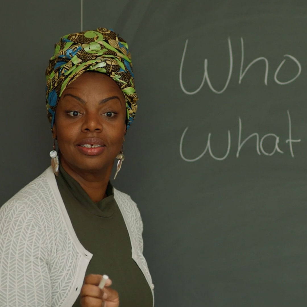 a black woman in front of blackboard