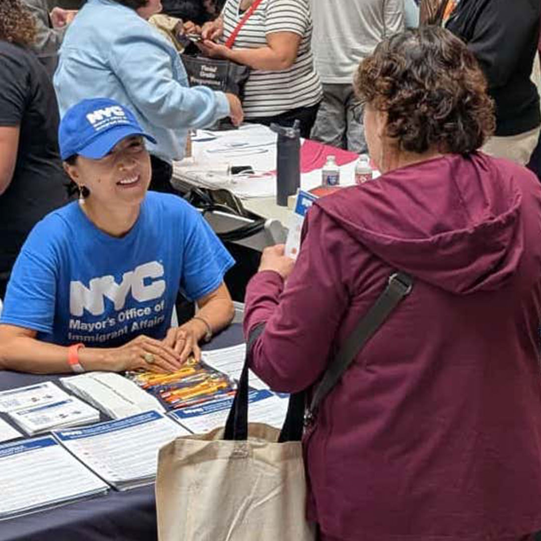 a woman is talking a MOIA outreach rep