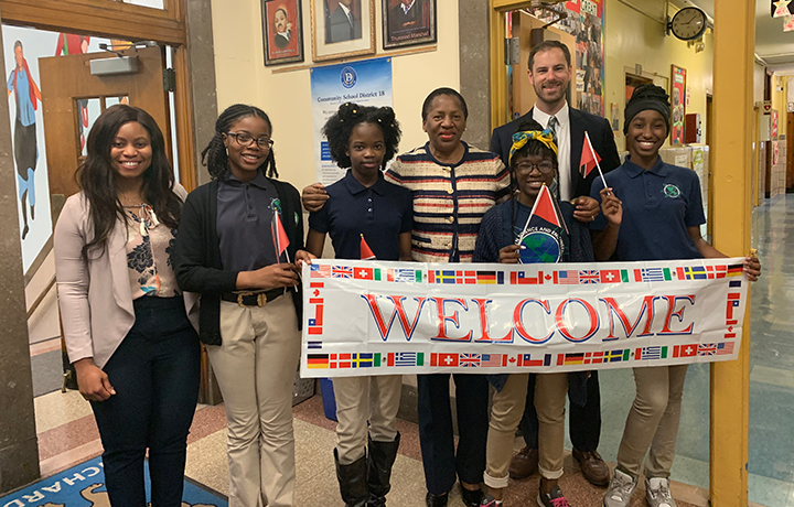 Students holding up a welcome sign
                                           