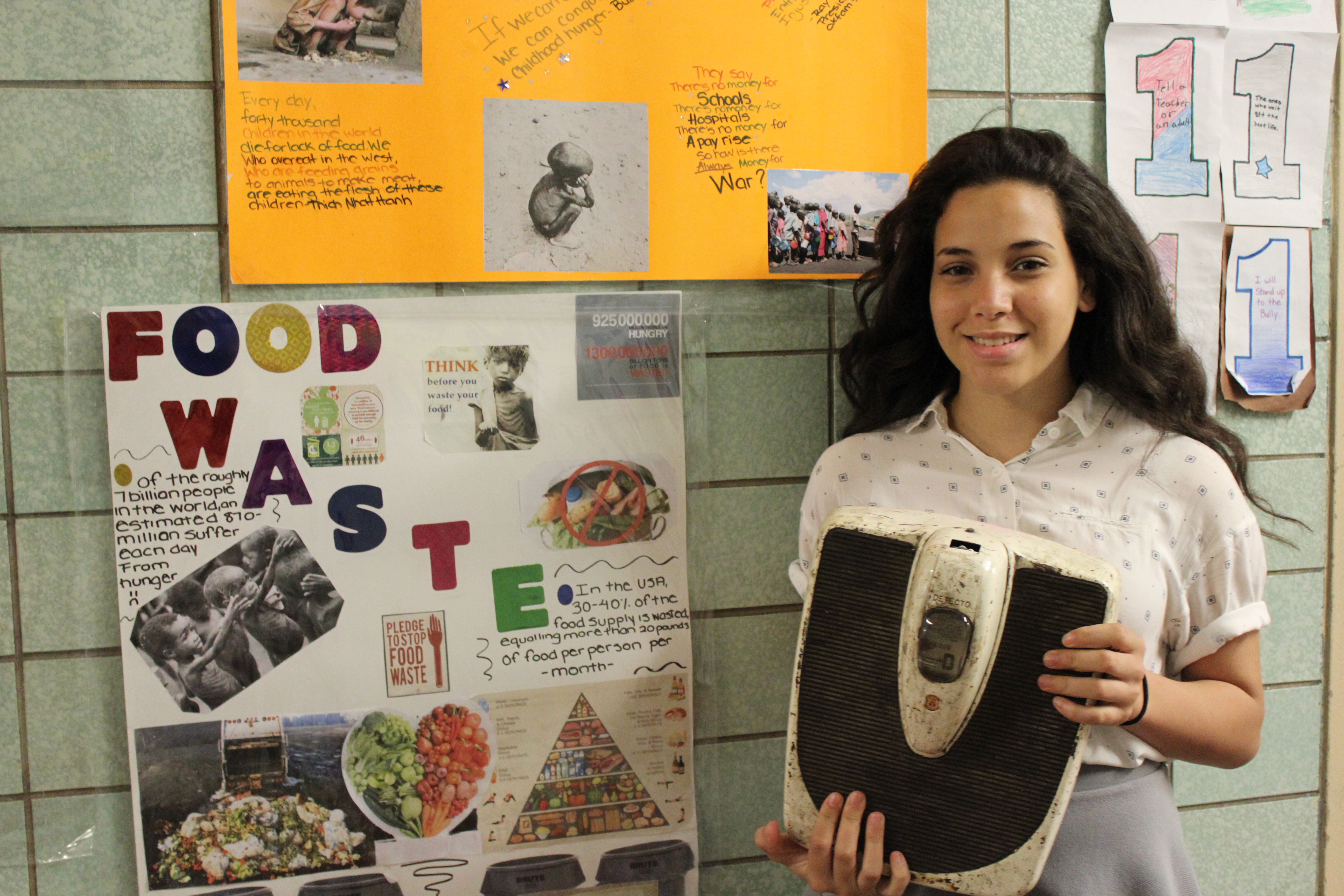 NYC Junior Ambassador holding up her art project
                                           