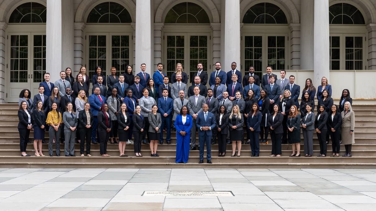 PICTURED (Center) Corporation Counsel Hinds-Radix, Mayor Adams, Mayor Adams’ Chief of Staff Frank Carone and the Mayor’s Chief Counsel Brendan McGuire stand with new Assistant Corporation Counsels.