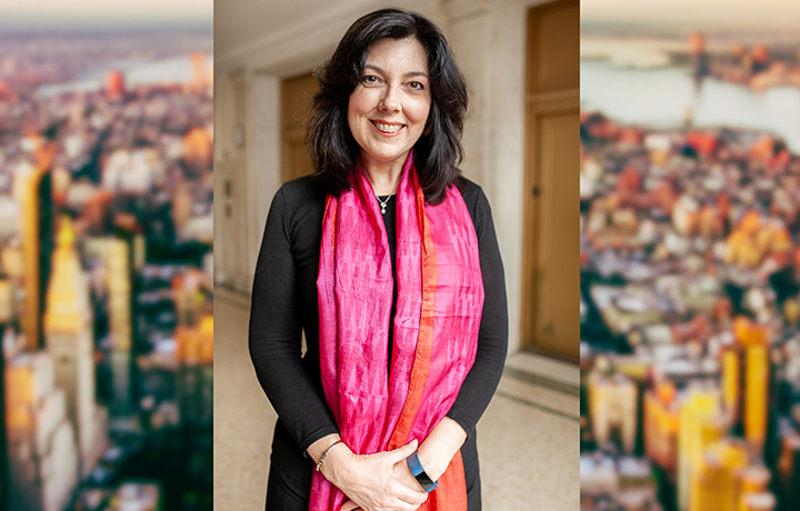 Photo of smiling person wearing a pink scarf; blurred aerial photo of New York City skyline in the background