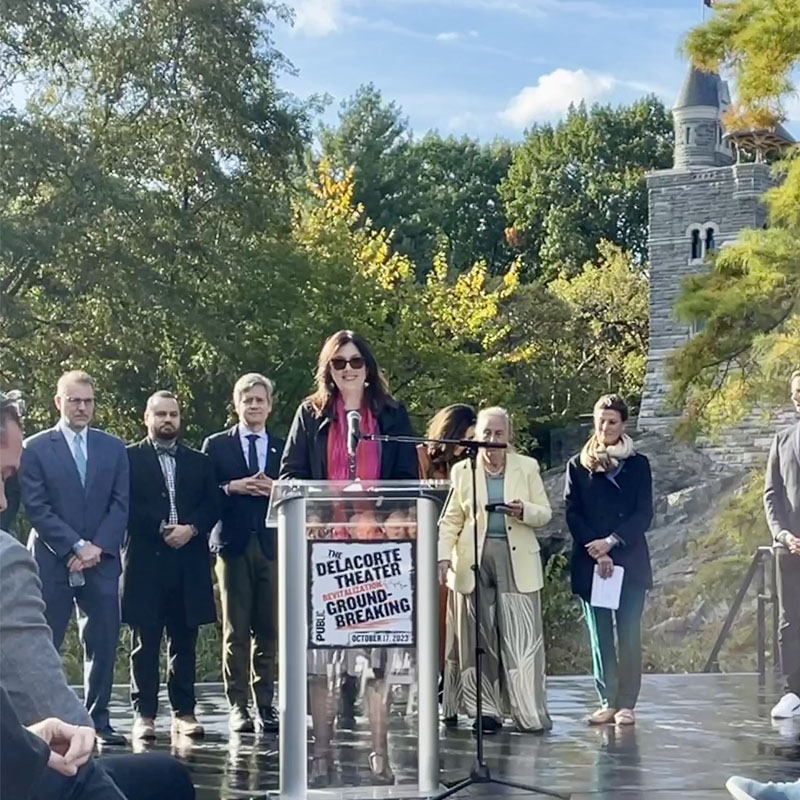 LPC Chair Carroll speaks at the Delacorte Theater with Central Park’s Belvedere Castle in the background