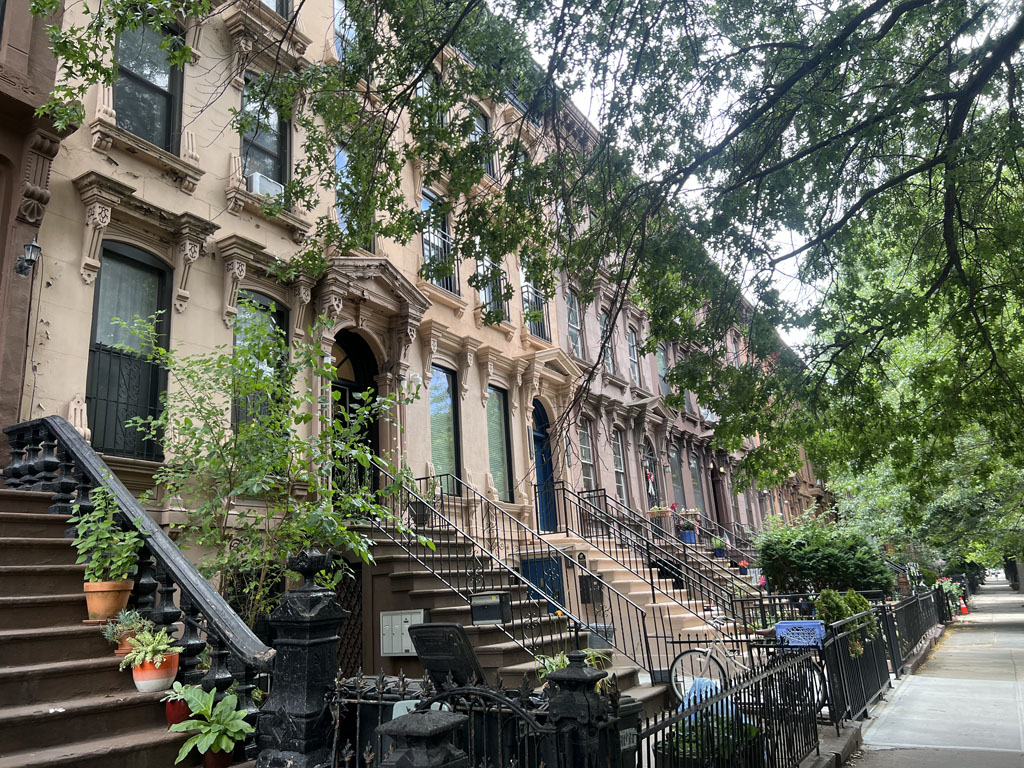Tree-lined block with a row of brownstones 