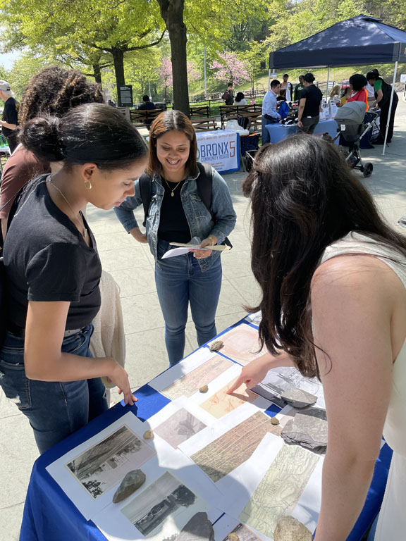 Smiling people pointing at papers on table