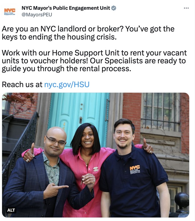 three people in front of the door step, two men and a woman in the middle