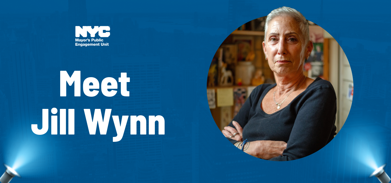 Graphic image with blue background and spotlights shining in the bottom corners reads, &ldquo;Meet Jill Wynn.&rdquo; A photo of Jill with her arms crossed is in a circle to the right of the text.