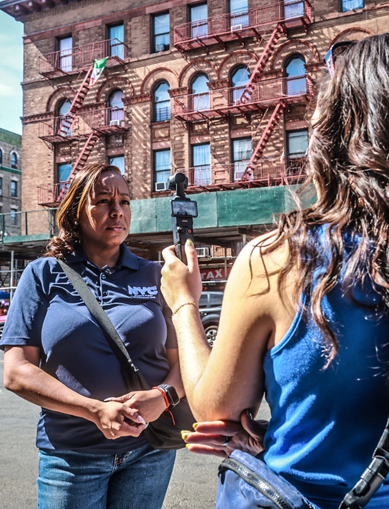 PEU staff member being interviewed by News Reporter on Bronx Street