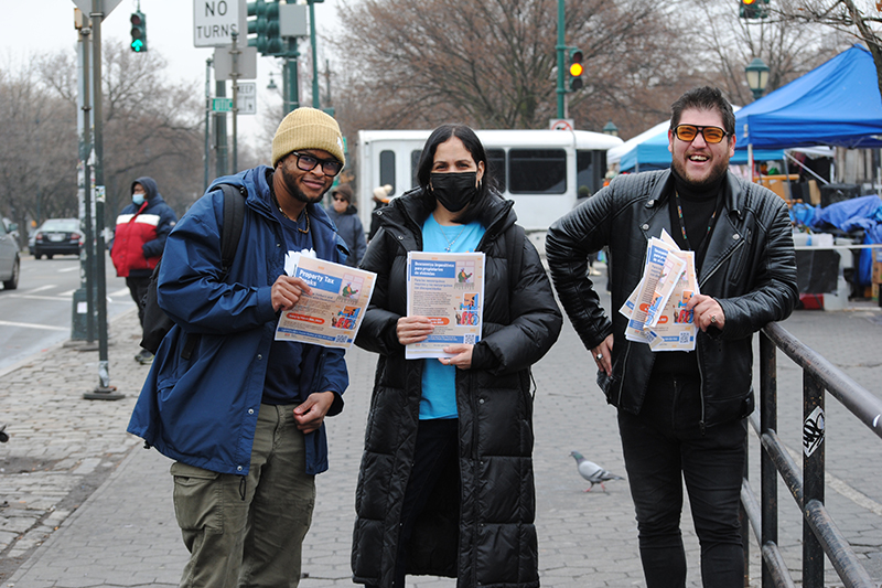 T S U Specialists stand on the sidewalk, posing with flyers about  property tax breaks