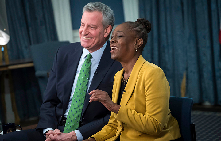 Mayor Bill de Blasio and First Lady Chirlane McCray smiling at the camera