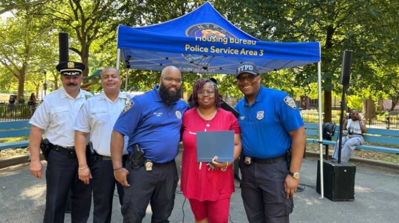 NYCHA leadership and residents celebrating National Night Out with local NYPD officers.
                                           