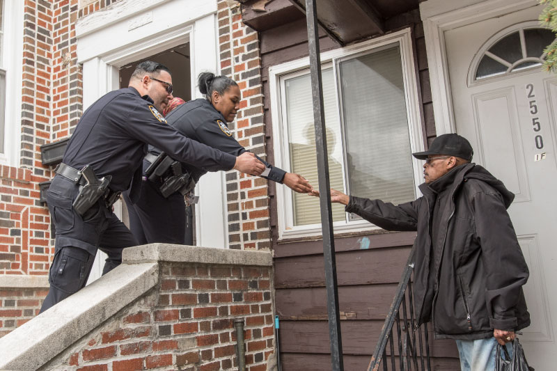 McDowell and Hernandez shaking hands with a local resident